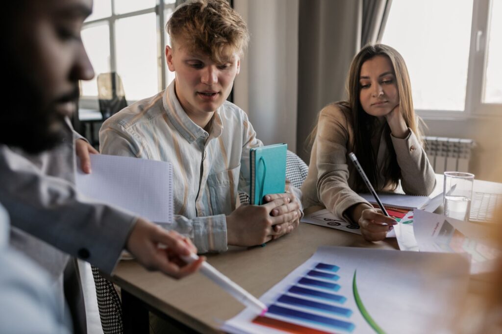 Colleagues collaborating around a table with notes and charts